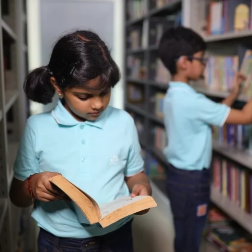Children reading book in the library at Cresmonde World School, Vikhroli